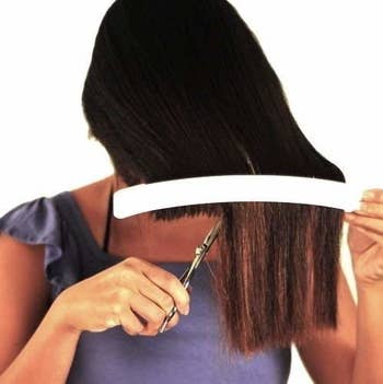 model using white clip to cut hair 