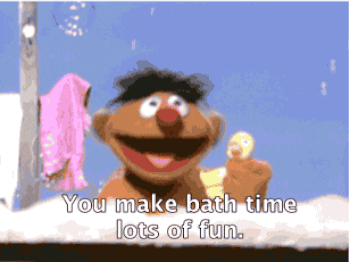 Ernie from Sesame Street singing &quot;You make bath time lots of fun&quot; to his rubber duck