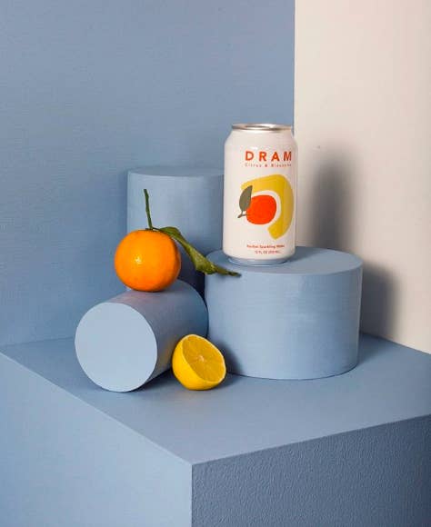Can of Dram with an orange and lemon 
