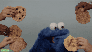 Cookie monster eating a bunch of cookies.