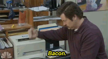 Ron Swanson from &quot;Parks and Rec&quot; showing his bacon hidden in a printer and saying &quot;Bacon.&quot;