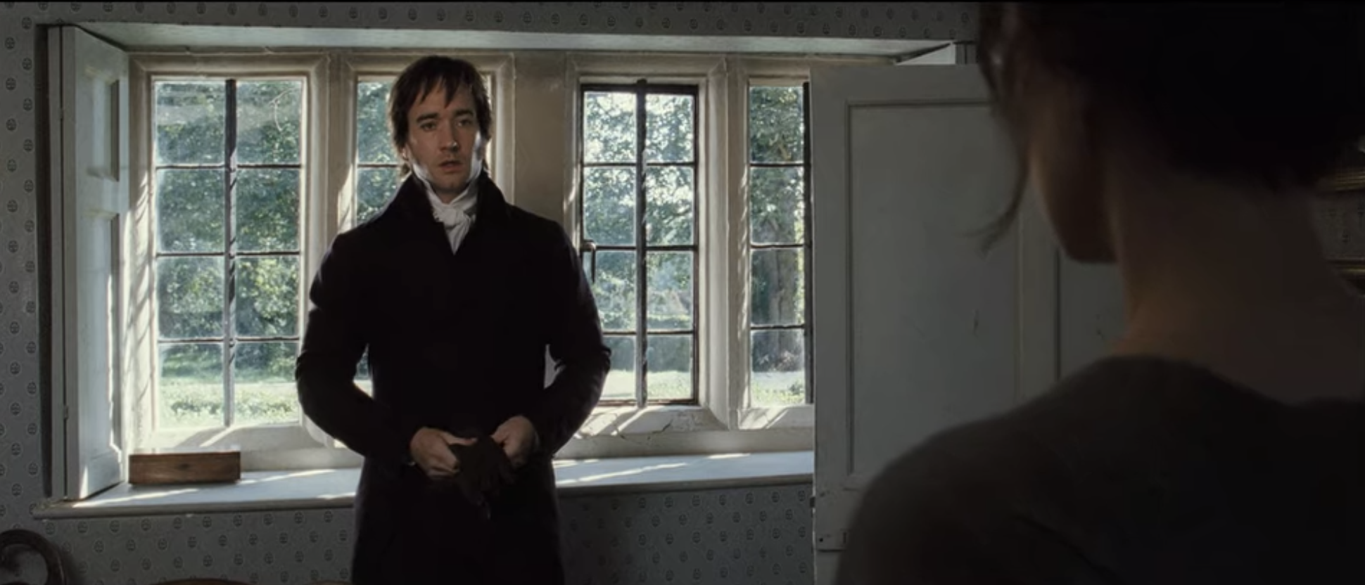 Mr. Darcy standing in Lizzie&#x27;s guest room. 