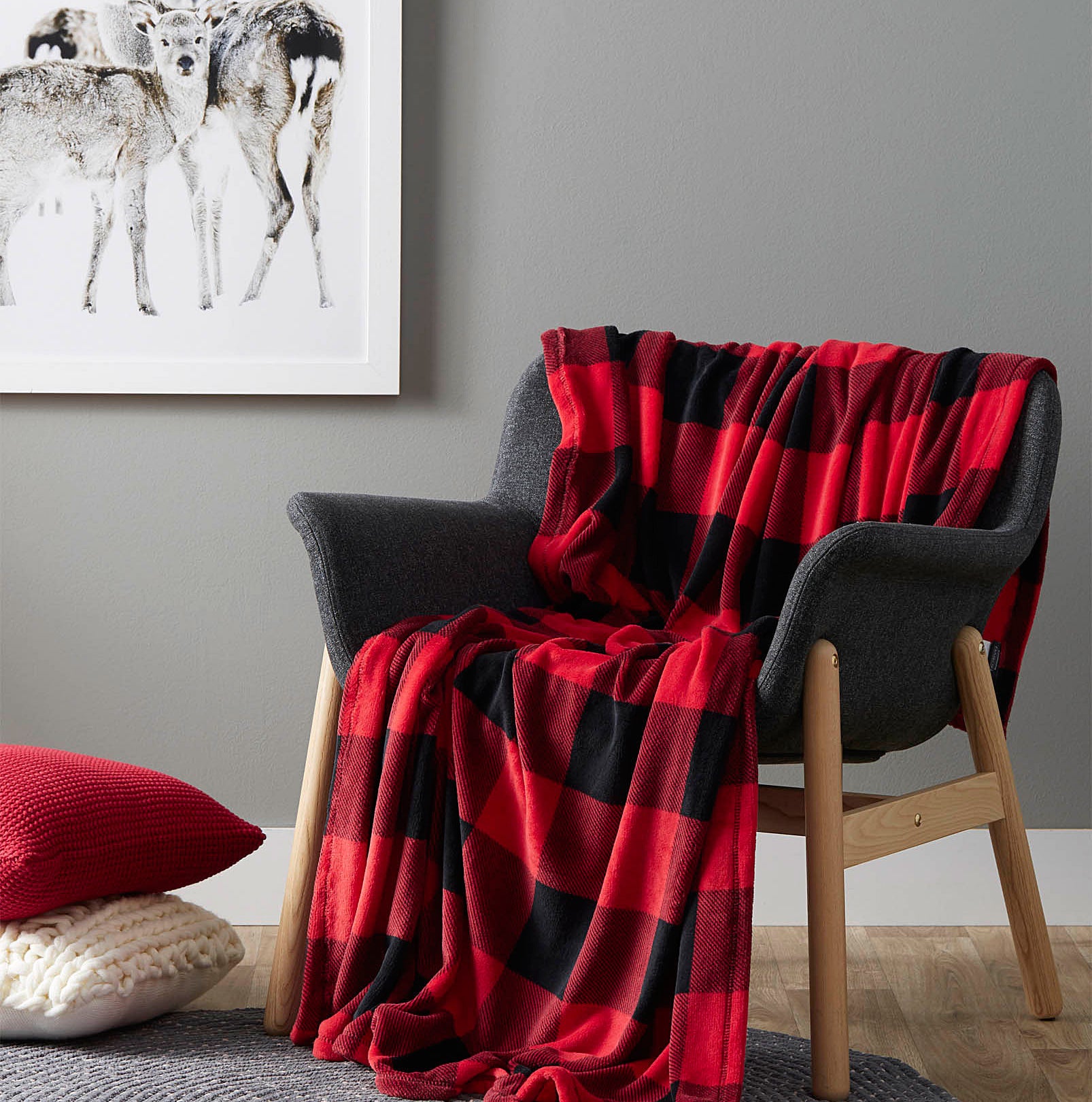 A soft throw blanket is draped over a wooden chair