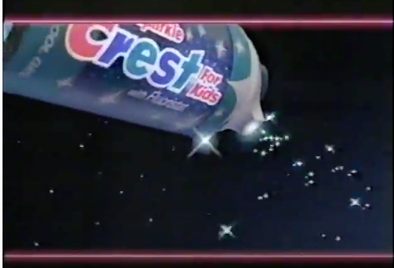 A screen shot from a commercial of Sparkle Crest for Kids tube flying through the sky 