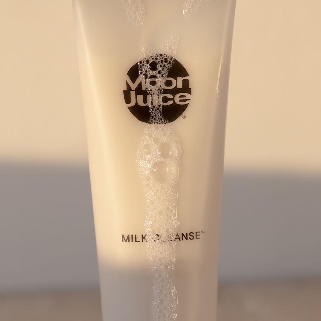 Bottle of the milk cleanse with foamy bubbles dripping down the side
