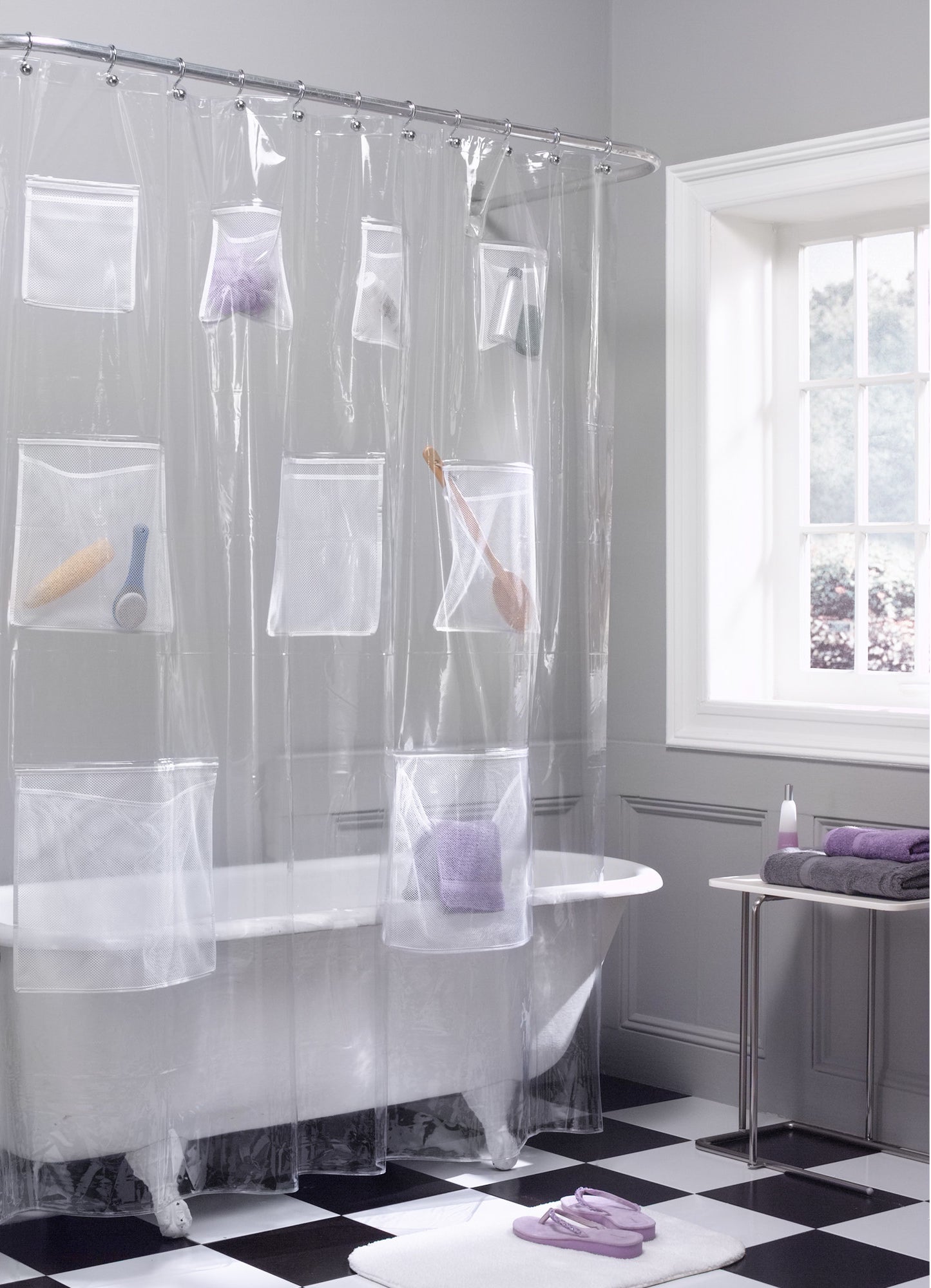 clear shower curtain with mesh pockets in a bathroom