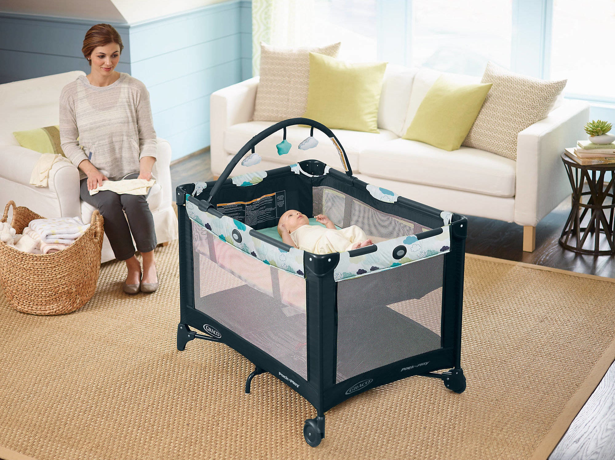 graco pack n play with a child in the bassinet