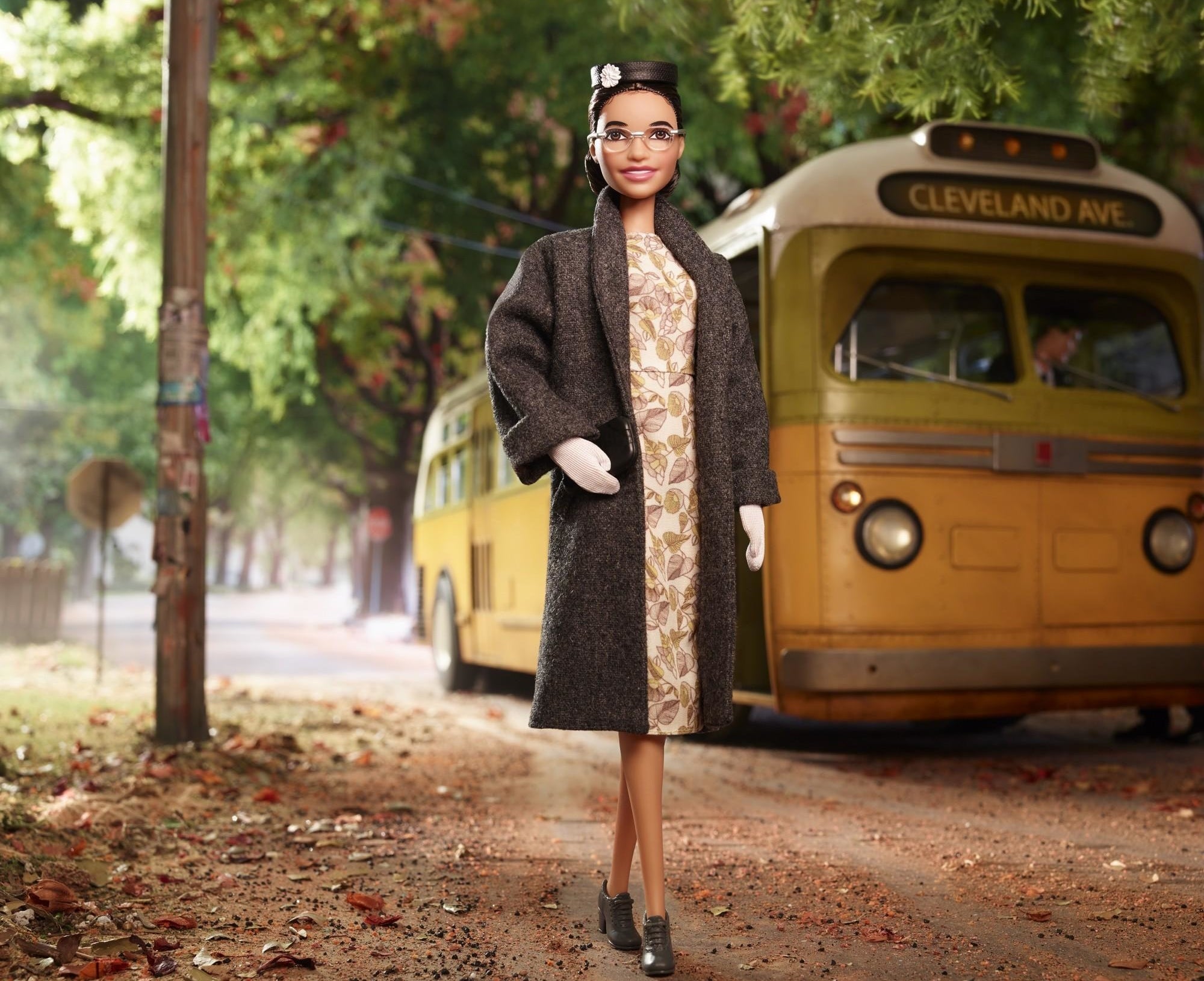 rosa parks barbie doll with a bus in the background