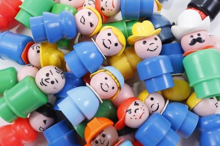 A pile of plastic Fisher-Price Little People from the 1980s