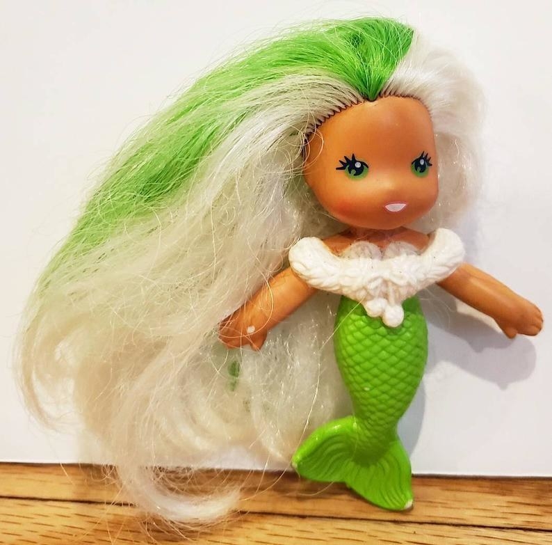 A Sea Wee mermaid doll with white hair and green streak