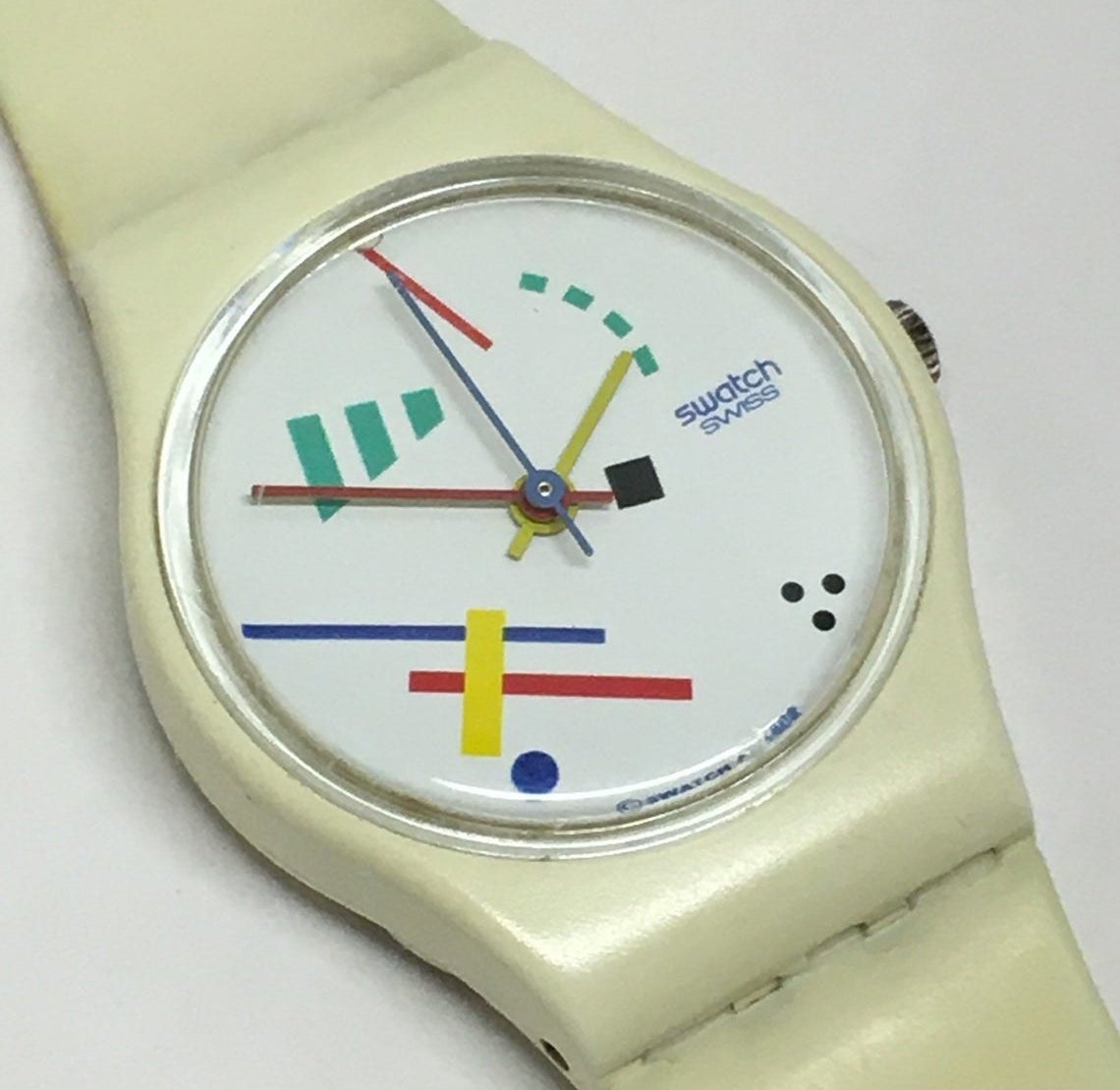 A close up of the face of a Swatch Watch