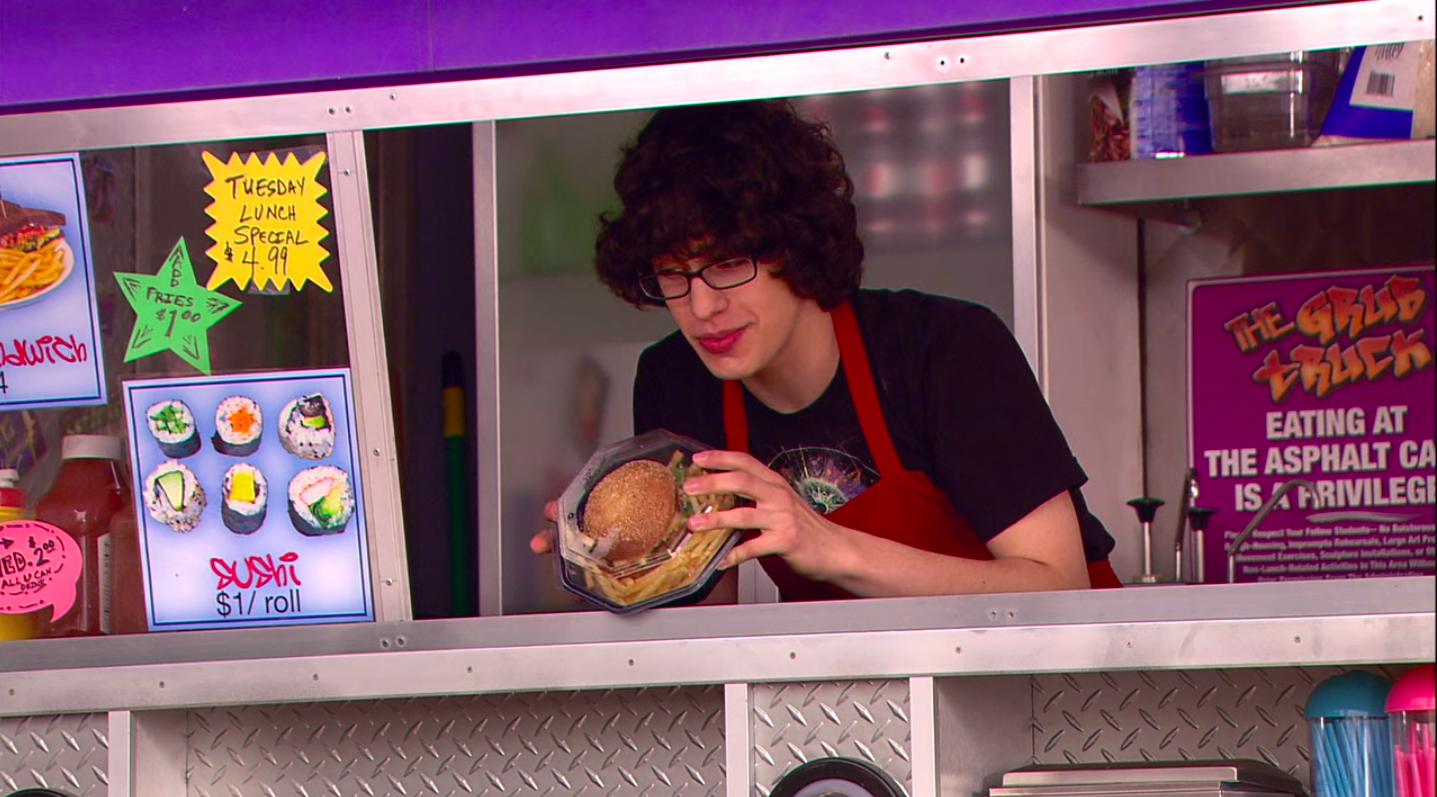 Robbie holds a packaged veggie burger in the Grub Truck food truck.
