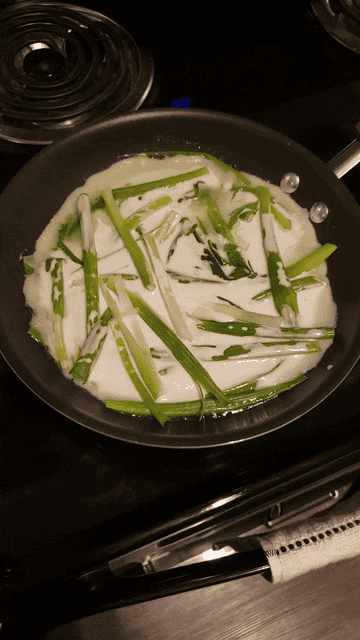 A GIF showing the raw pancake as it cooks in the pan and the vegetable oil sizzles around the edges