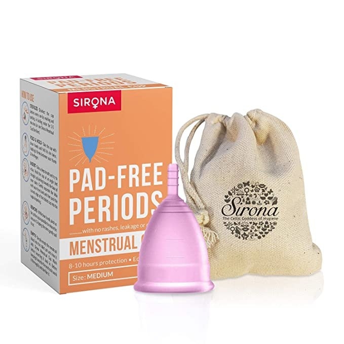 Pink silicone menstrual cup with a cloth pouch.