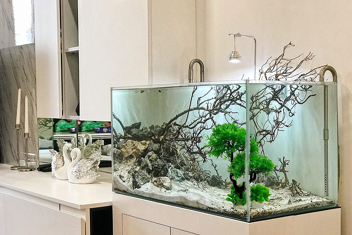 Miniature tree placed inside a fish tank.