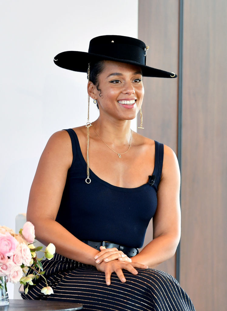 Alicia Keys wearing a hat and smiling