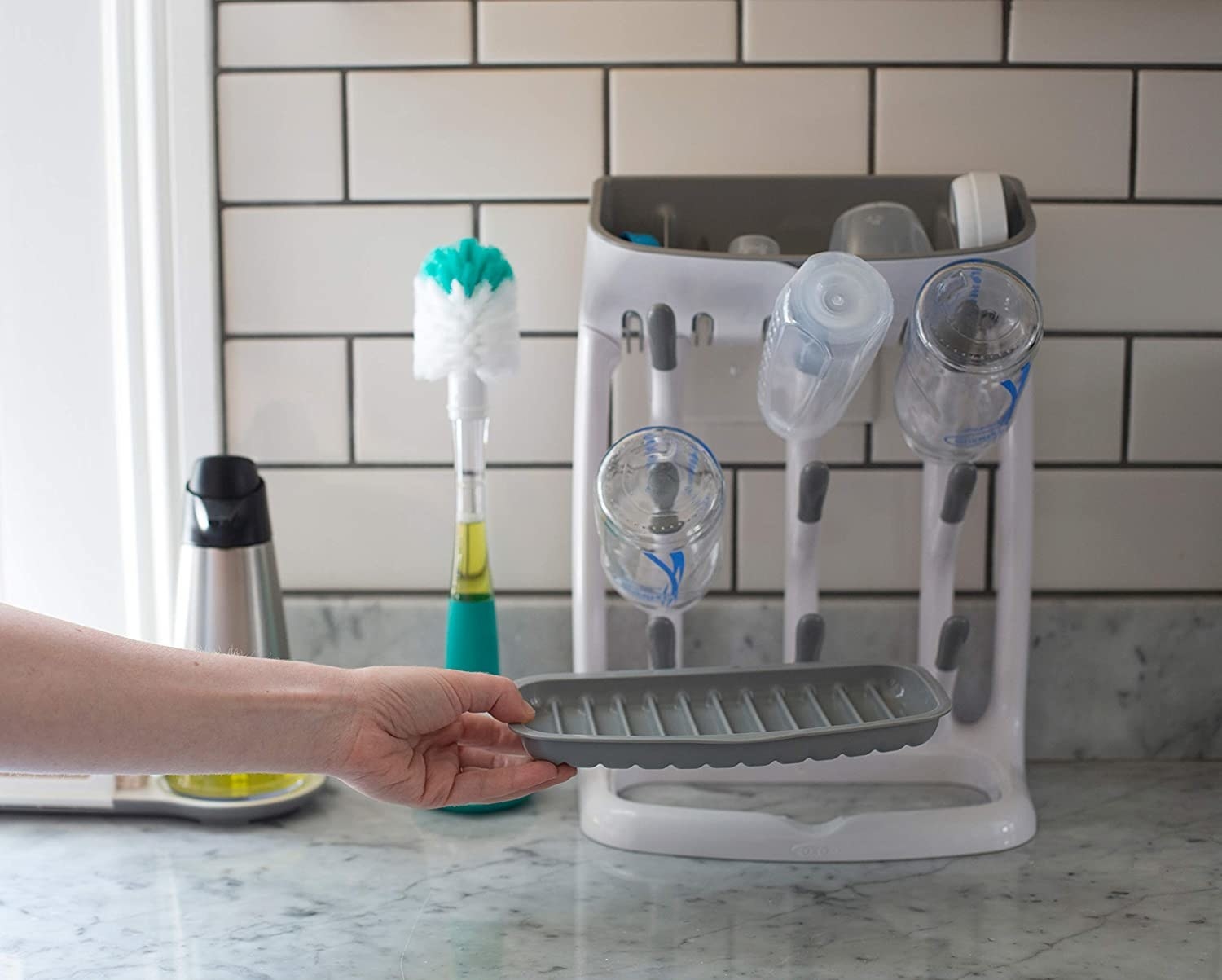 The OXO bottle drying rack on a kitchen counter.