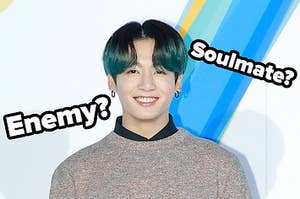 Jungkook smiles and the words soulmate or enemy are placed around him