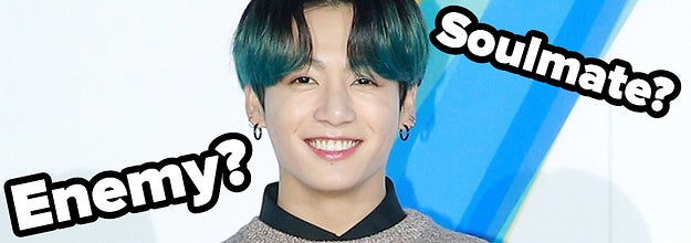 Jungkook smiles and the words soulmate or enemy are placed around him