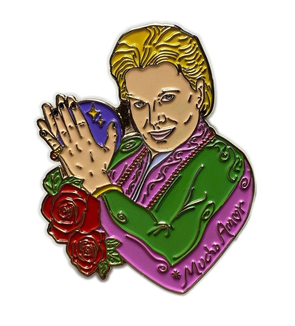 A pink- and green-clad Walter Mercado pin with red roses