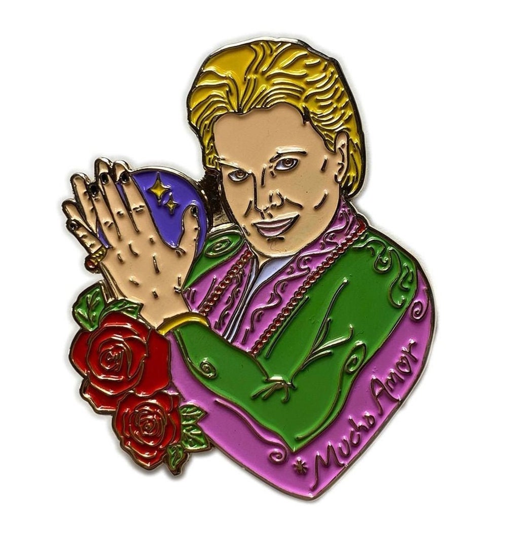 A pink- and green-clad Walter Mercado pin with red roses