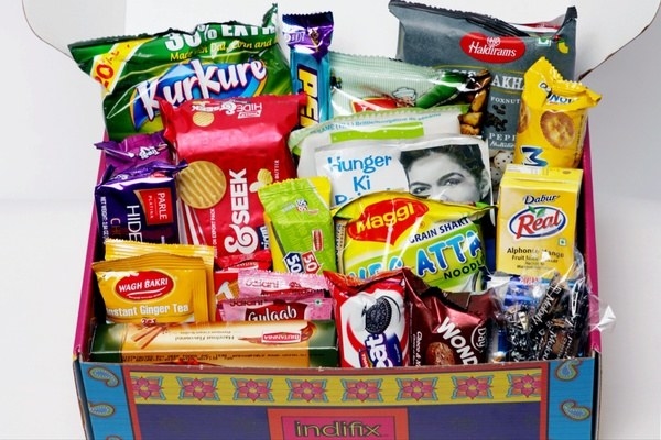 The IndiFix box filled with an assortment of Indian snacks