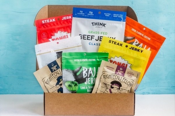 A box filled with various bags of jerky