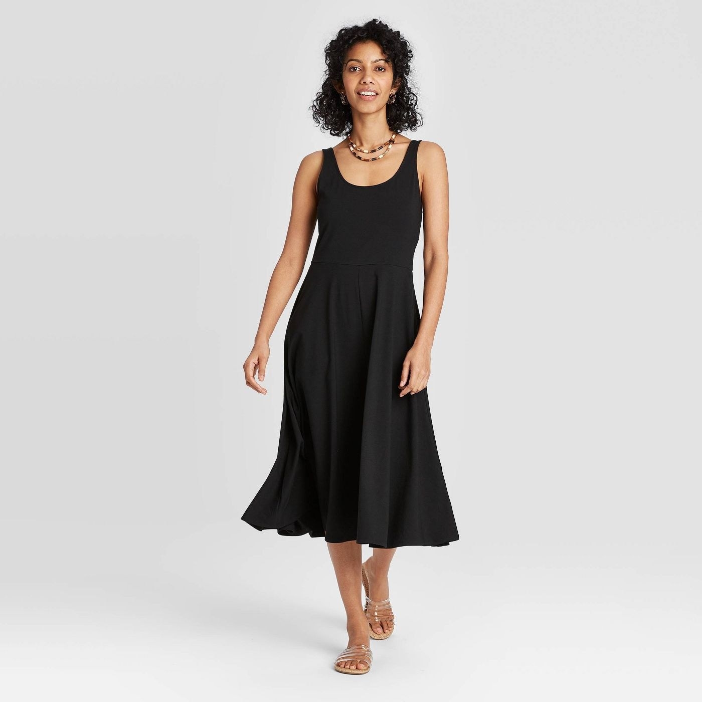 Model in flowy black midi dress