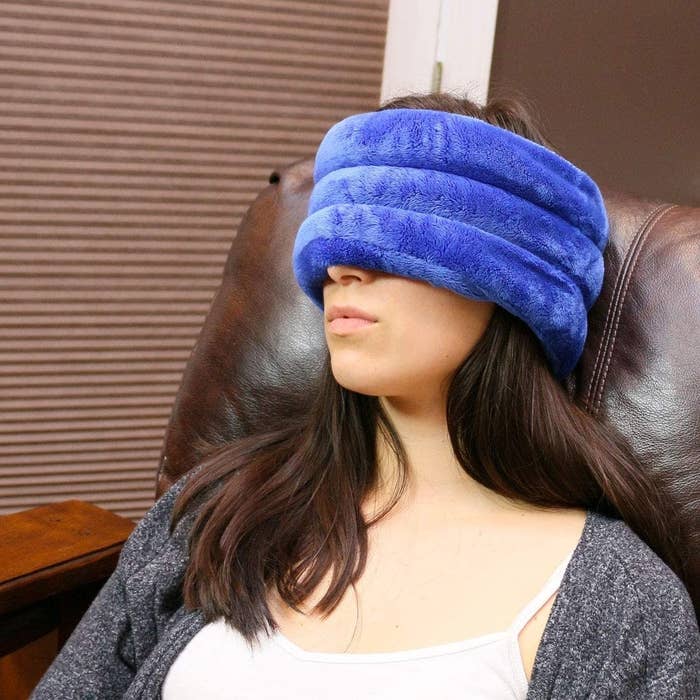 A model wearing the thick blue plush wrap around the top of their head and eyes