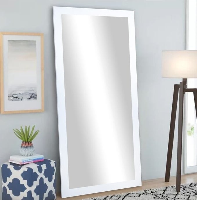 The white-framed full-length mirror