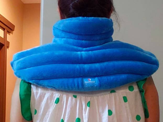 A reviewer wearing the blue plush wrap