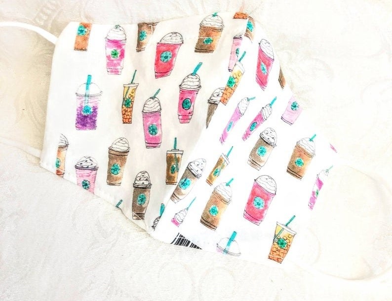 white face mask with watercolored starbucks drinks on it 