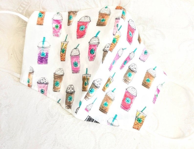 white face mask with watercolored starbucks drinks on it