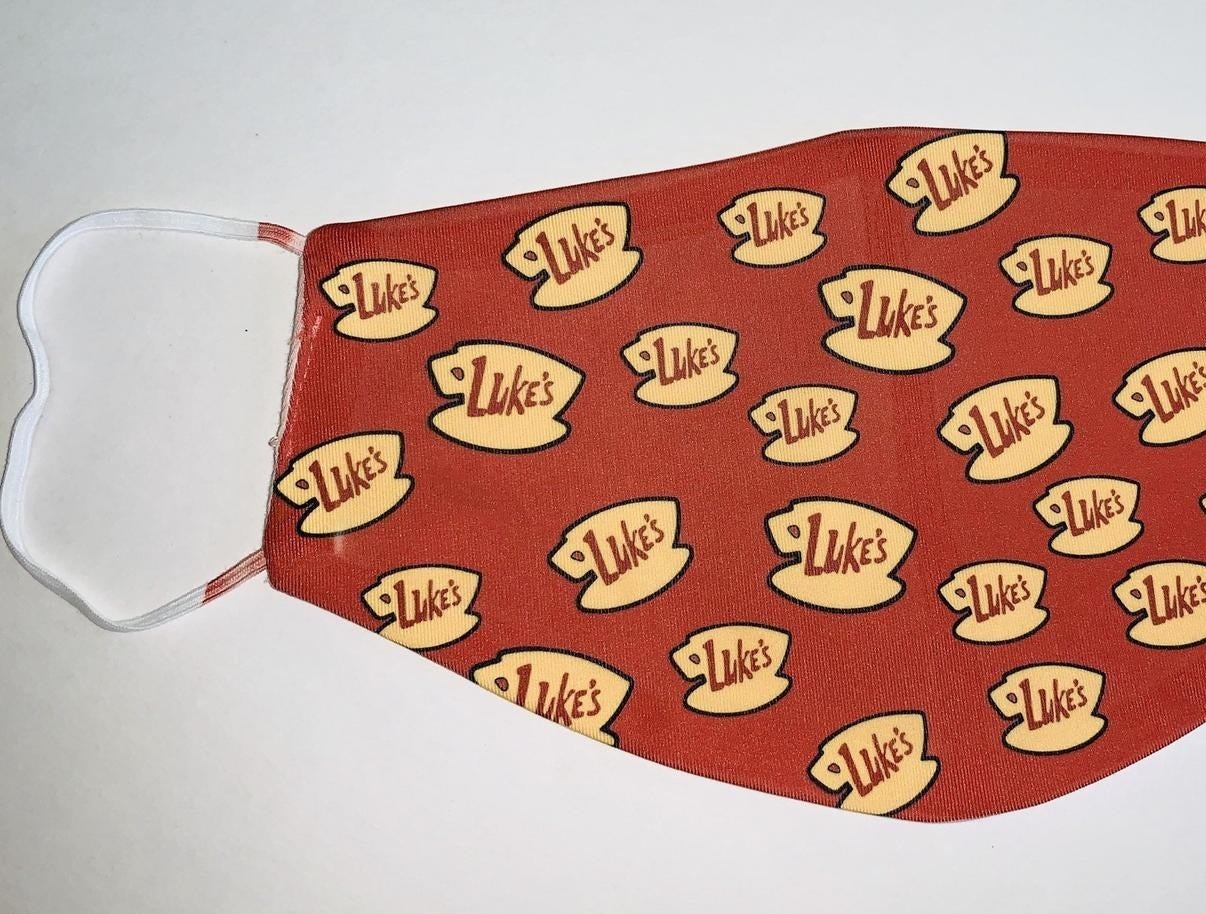 Red face mask with Luke's Diner logos on it