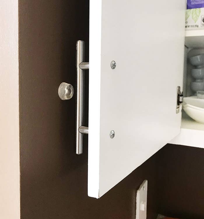 A door bumper protecting a wall from a cabinet door