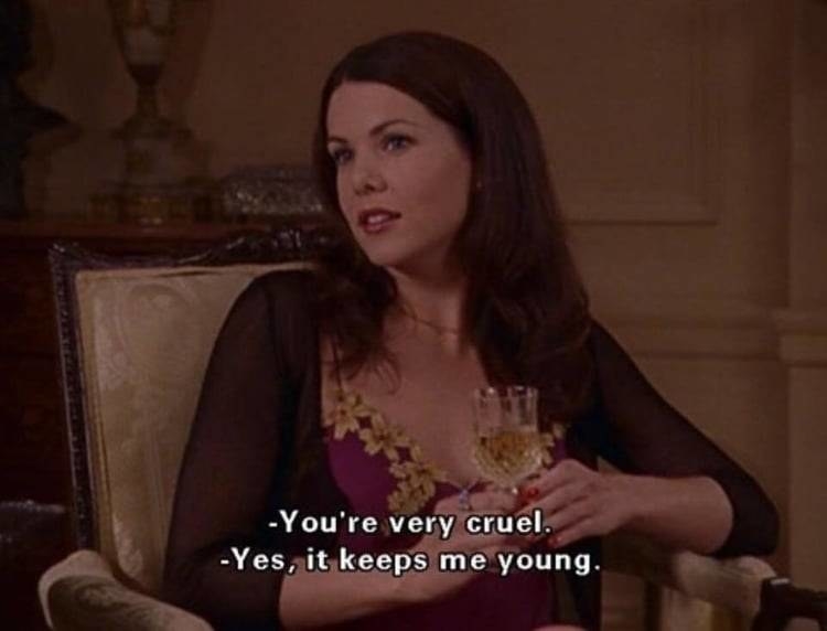 Lorelai sitting in her parents&#x27; living room, driving a glass of champagne