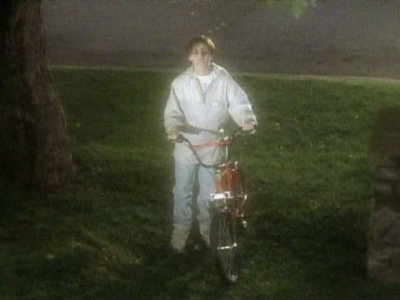 a ghost of a boy with a red bike