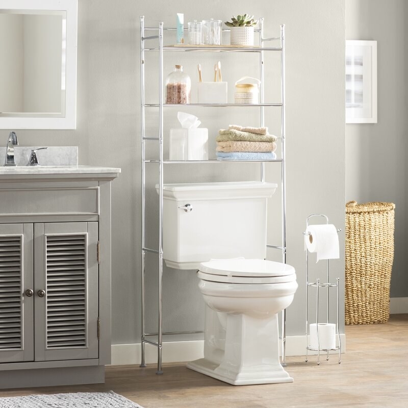 A chrome over-the-toilet storage unit with three shelves