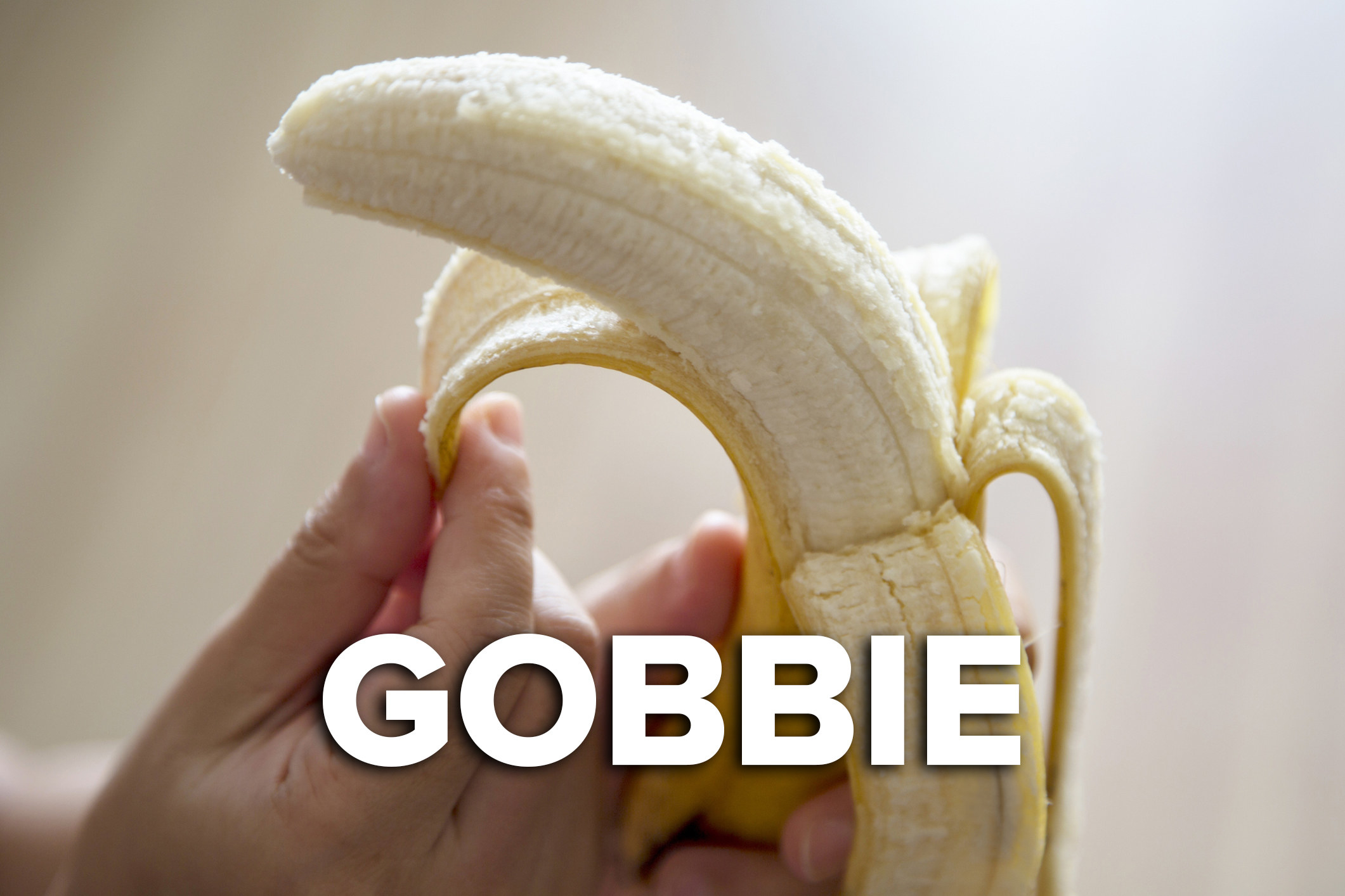 A hand peeling a banana