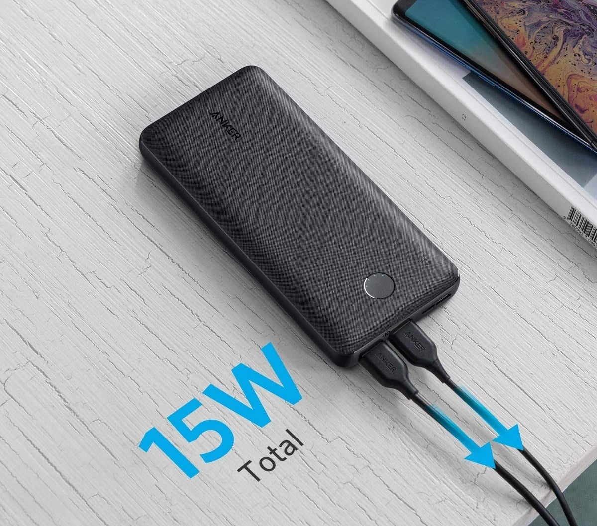 A power bank with two cords plugged in