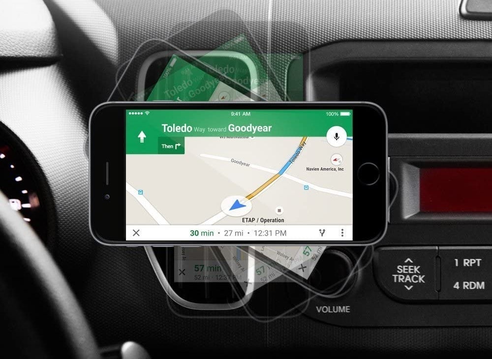 A phone shows navigation while mounted to a car