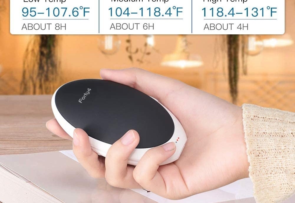 A person holds a hand warmer