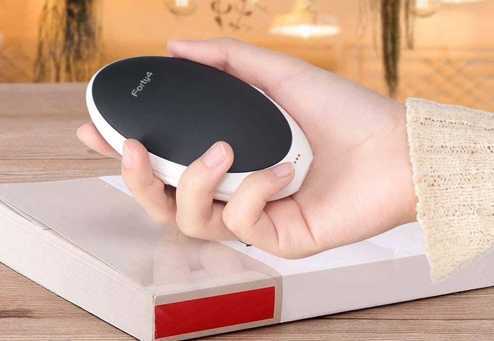A person holds a hand warmer