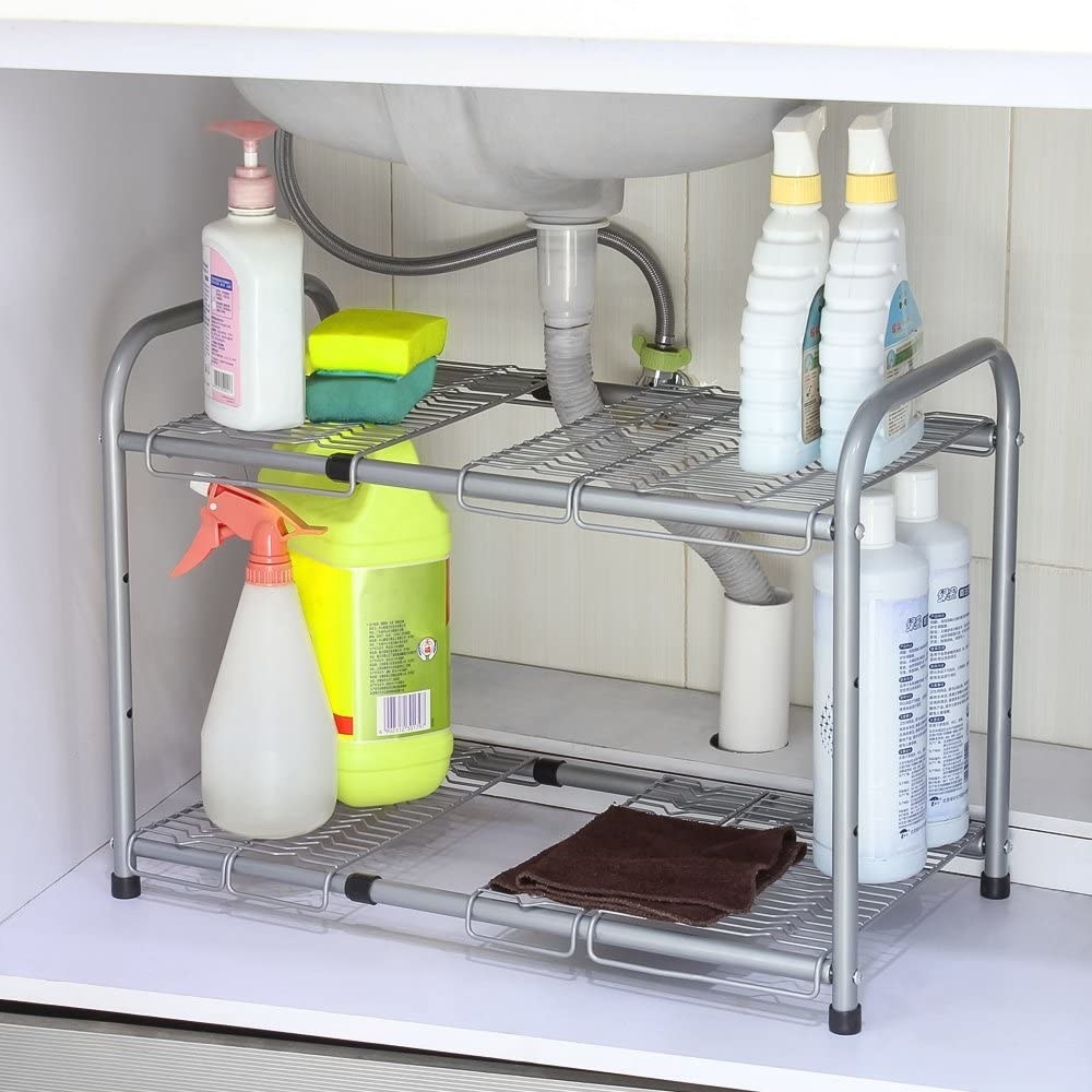 Cleaning supplies on the shelf under a sink