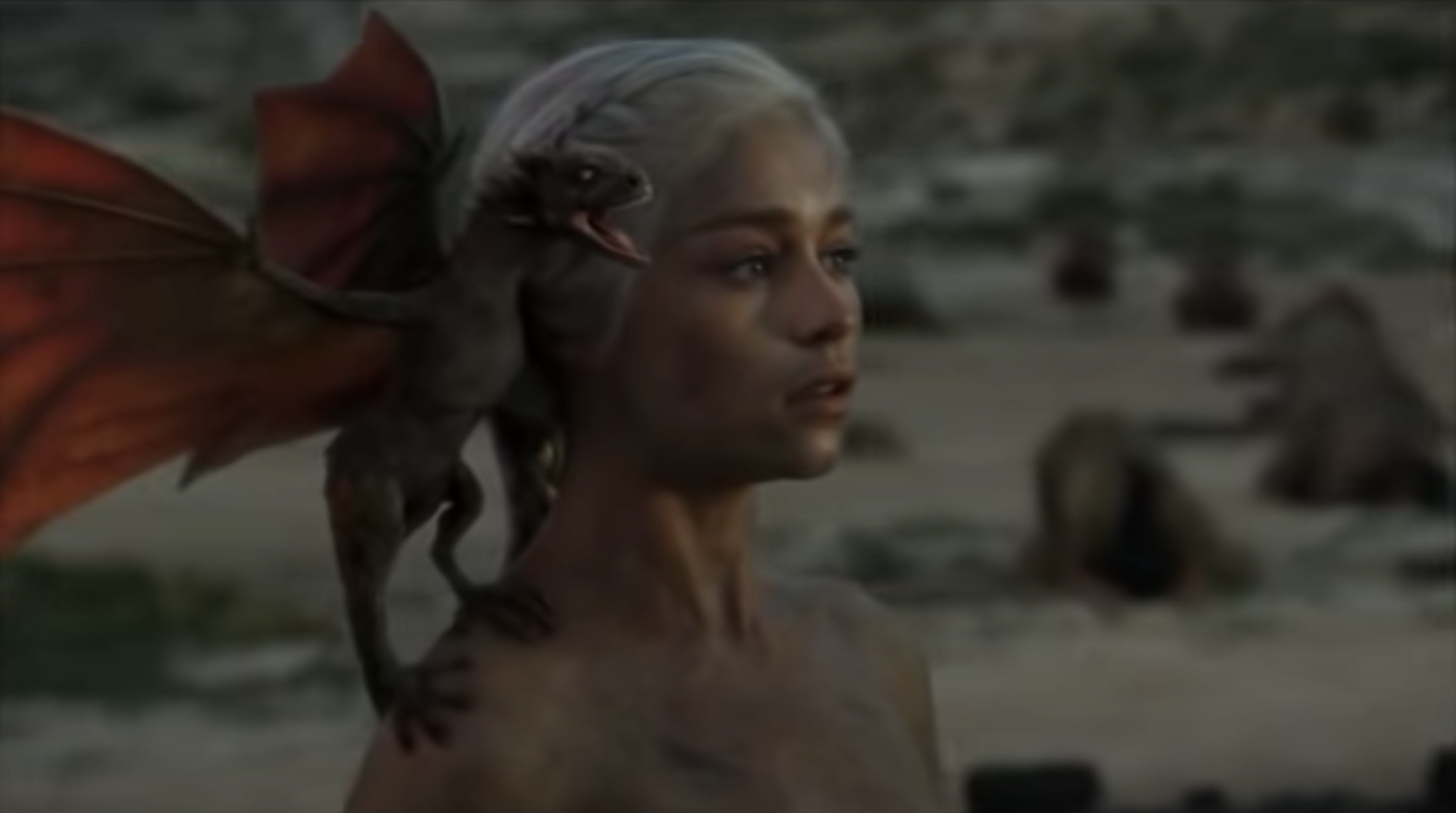 Still from Game of Thrones: Daenerys is covered in ashes with a baby dragon on her shoulder