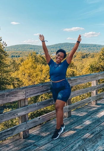 Reviewer wearing the bike shorts in a blue snake print
