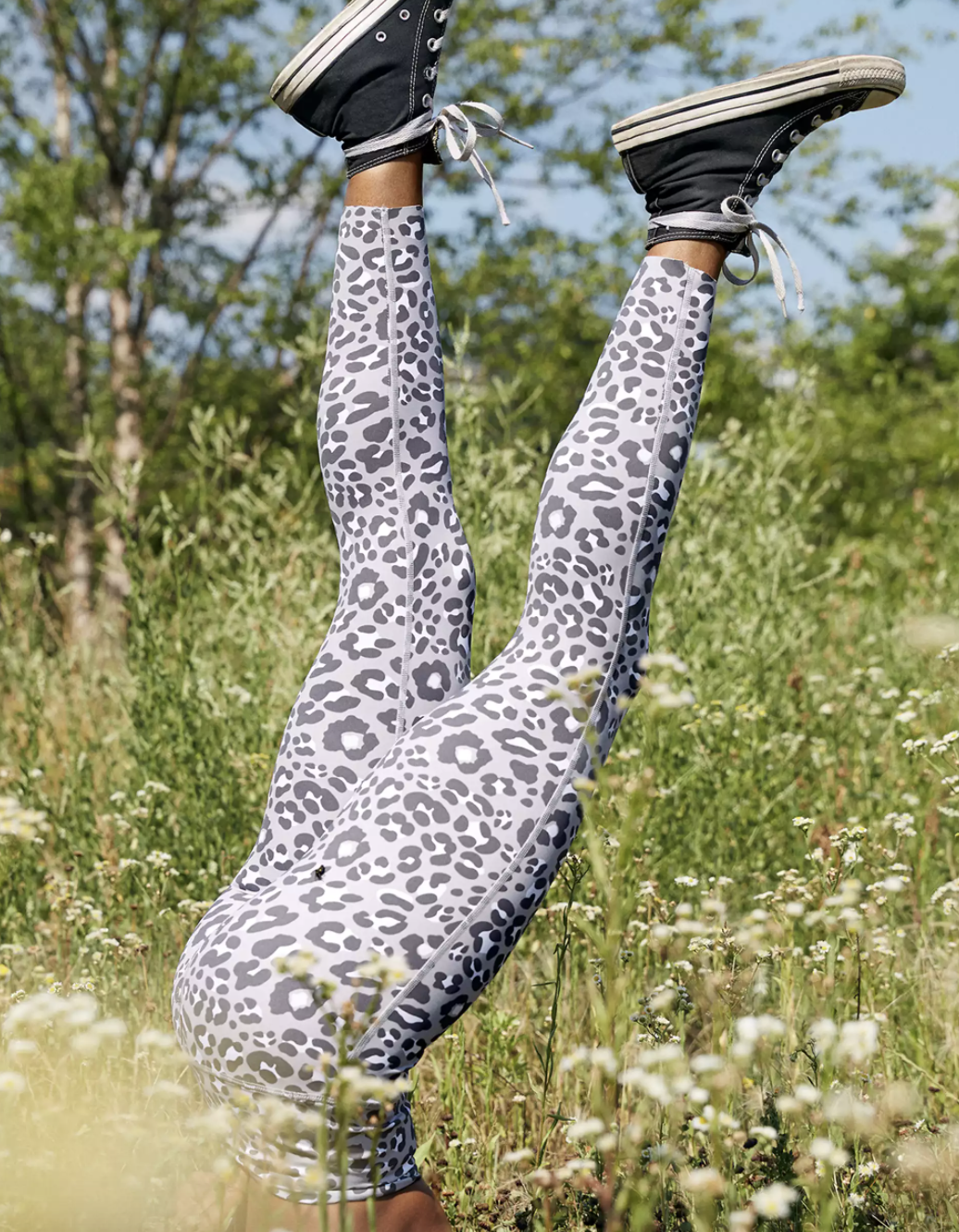 a model in grey leggings with a darker grey cheetah print on them