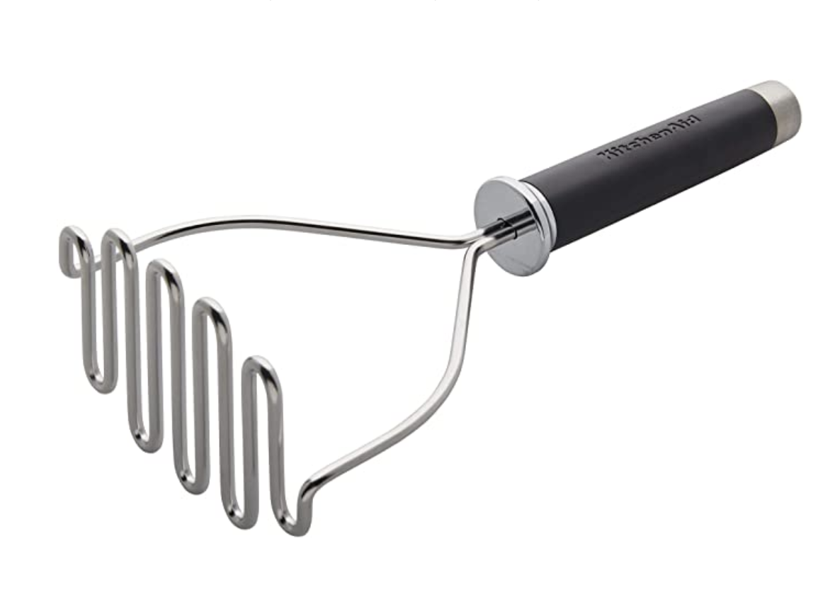 A stainless steel potato masher.