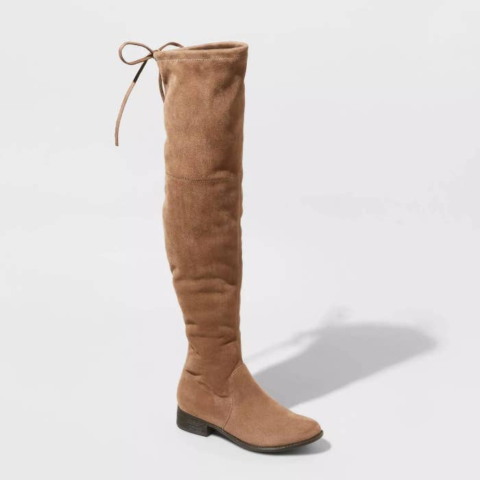 A taupe pair of microsuede, over-the-knee boots with a drawstring cord top