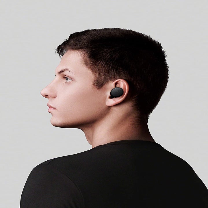Side profile of a person wearing the earphones.
